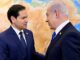 Two men in suits shaking hands.