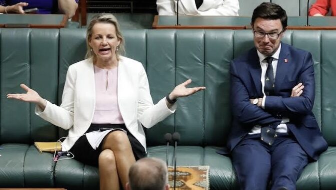 Politicians in discussion during a parliamentary session.