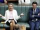 Politicians in discussion during a parliamentary session.