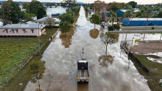 Truck driving through flooded street in town. Truck driving through flooded street in town.