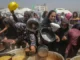 People gathering for food distribution in camp.