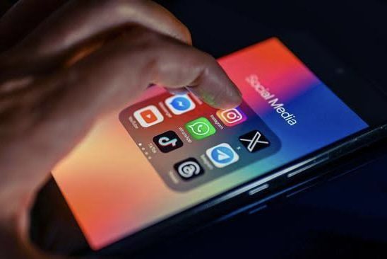 Hand touching smartphone with social media apps. Hand touching smartphone with social media apps.