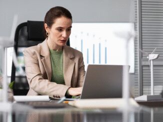 Woman working on laptop in office.
