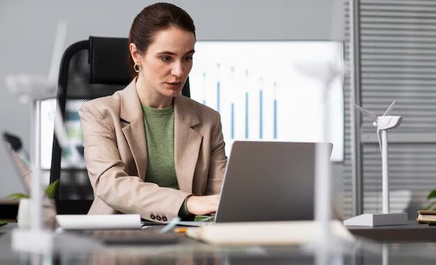 Woman working on laptop in office. Woman working on laptop in office.