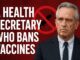 Man in suit with anti-vaccine symbol.