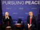 Two men seated at "Pursuing Peace" event.