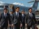 Men in suits walking from private jet.