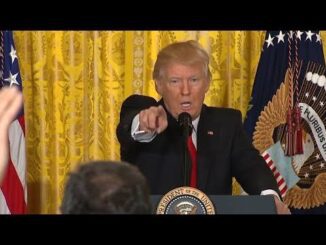 Politician pointing during a press conference.
