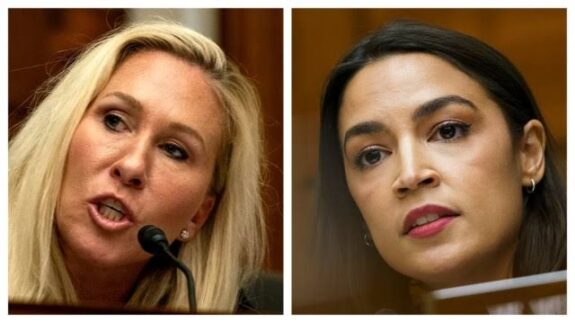 Two women speaking at a public event. Two women speaking at a public event.