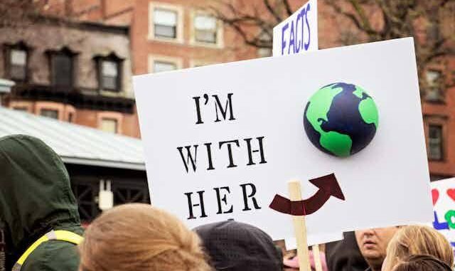 Protest sign with "I'm with her" message. Protest sign with "I'm with her" message.