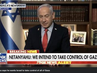 Man speaking in TV interview with news banner.