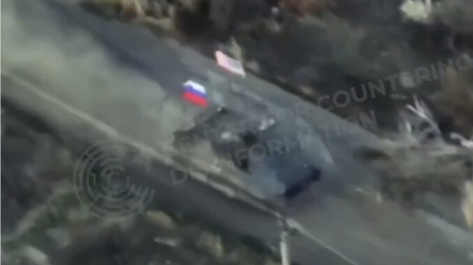Aerial view of vehicle with flags on road. Aerial view of vehicle with flags on road.