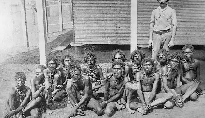 A historical photograph of chained individuals.