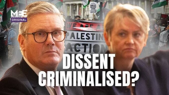 Protest backdrop with "Dissent Criminalised?" text.