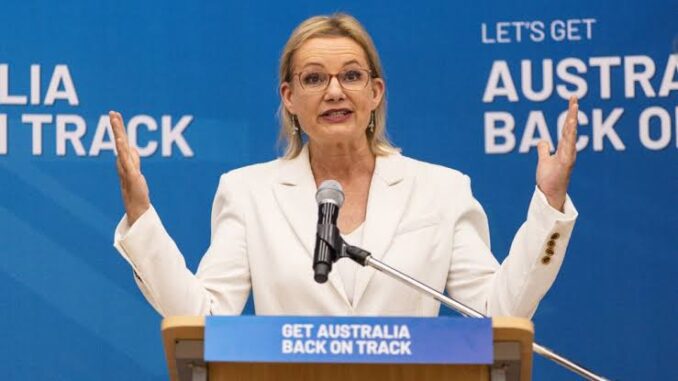 Woman speaking at podium with raised hands. Woman speaking at podium with raised hands.