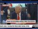 Man speaking at desk during press briefing.