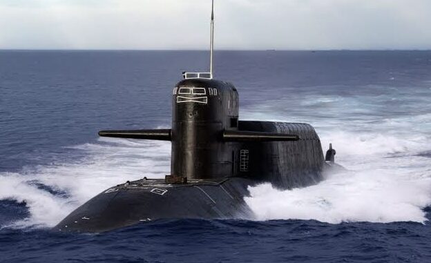 Submarine surfacing in the open ocean waters.