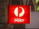 Australia Post sign on building exterior.