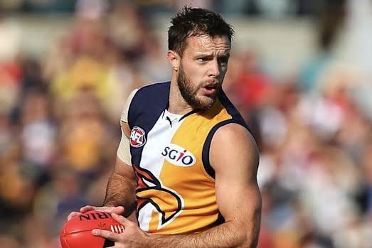 AFL player holding ball during game.