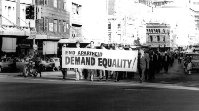 Protesters marching with "End Apartheid" banner. Protesters marching with "End Apartheid" banner.
