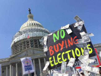 Protest sign against buying elections, Capitol backdrop.