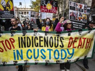 Protesters holding "Stop Indigenous Deaths in Custody" banner.