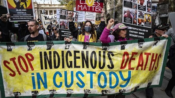 Protesters holding "Stop Indigenous Deaths in Custody" banner. Protesters holding "Stop Indigenous Deaths in Custody" banner.