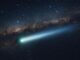 Bright comet streaking across starry night sky.