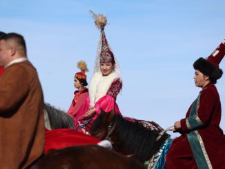 People in traditional attire riding horses.