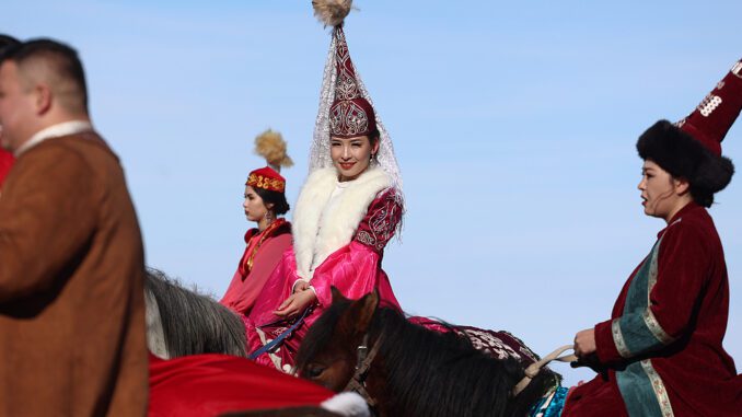 People in traditional attire riding horses. People in traditional attire riding horses.