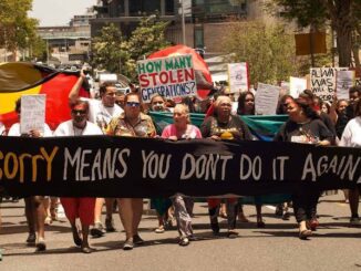 Protesters marching with signs and banners.