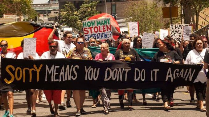 Protesters marching with signs and banners. Protesters marching with signs and banners.