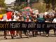 Protesters marching with signs and banners.