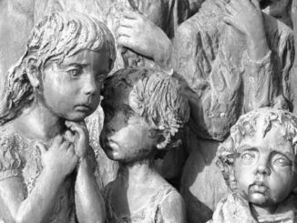 Children sculpture with somber expressions.