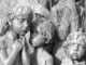 Children sculpture with somber expressions.