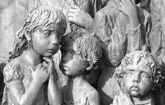 Children sculpture with somber expressions. Children sculpture with somber expressions.