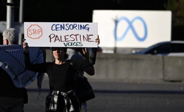 Protester holding sign about Palestine censorship.