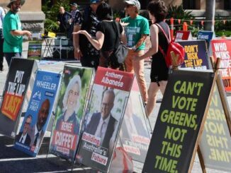 Political campaign posters displayed outdoors.