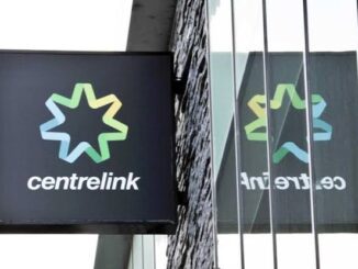 Centrelink sign with reflection on glass.
