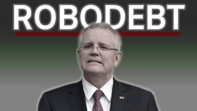 Man in suit under "Robodebt" sign. Man in suit under "Robodebt" sign.