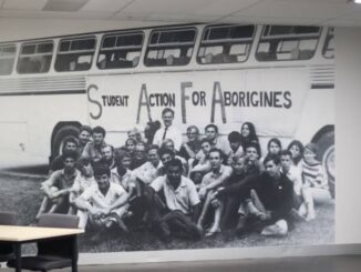 Group photo in front of a bus.