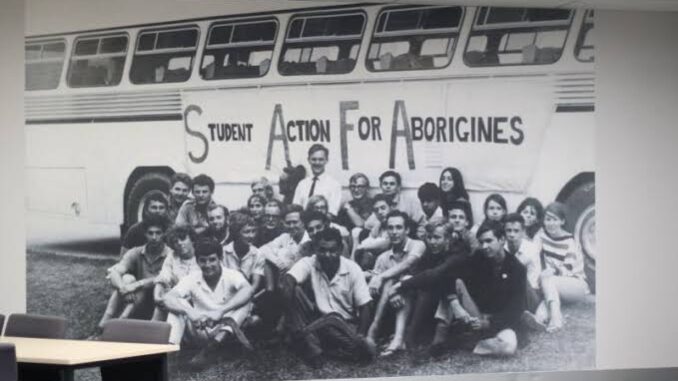 Group photo in front of a bus.