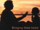 Silhouettes of adult and child at sunset.
