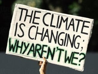 Sign reads: "The climate is changing, why aren't we?