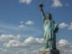 Statue of Liberty against a cloudy sky.
