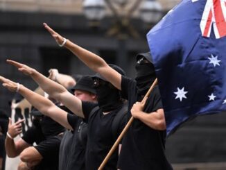 Protesters with Australian flag making salute gesture.
