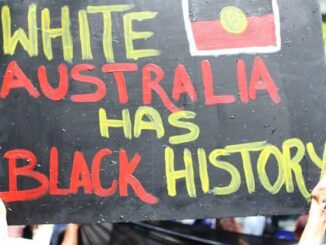 Protest sign reading "White Australia Has Black History.