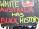 Protest sign reading "White Australia Has Black History.