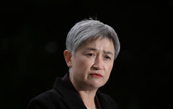 Person with short hair and serious expression. Person with short hair and serious expression.