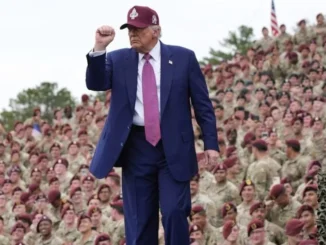 Man in suit with crowd of soldiers.